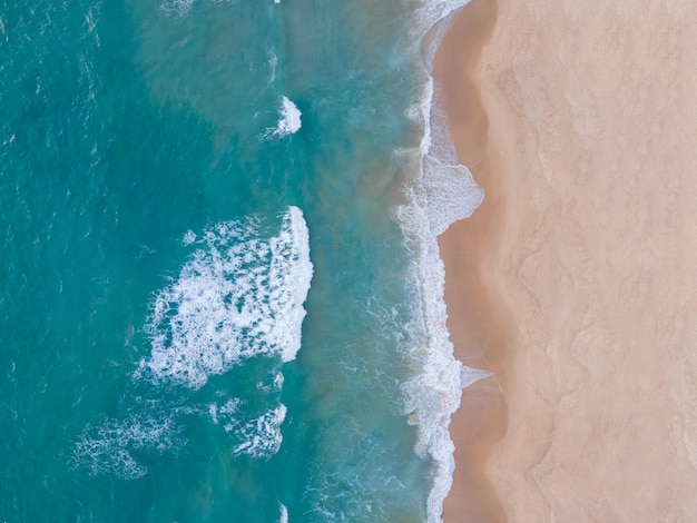 Aerial view Top-down seawater wave on sandy beach. Aerial view above beach sea in tropical beach sea