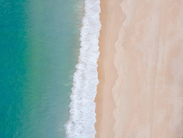 Aerial view of top view beach and crystal seawater on sandy beach in summer. Nature, travel concept