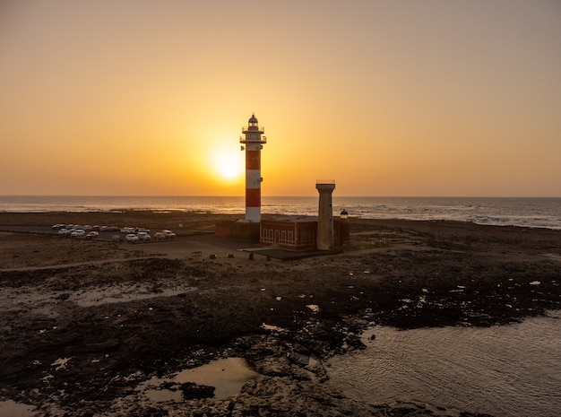 Aerial view of the Toston Lighthouse at sunset, Punta Ballena near the town of El Cotillo, Fuerteventura island, Canary Islands. Spain