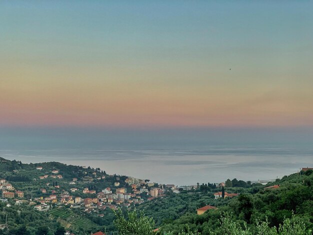 Aerial view of townscape against sky at sunset