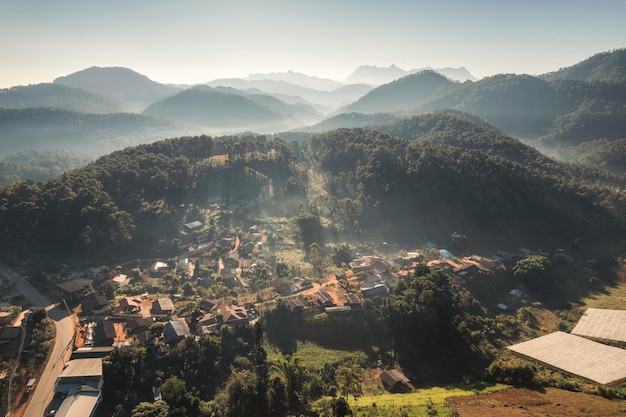 Aerial view of traditional tribe village in foggy among the valley and mountain layer in the morning at Khun Kong Chiang Dao Chiang Mai Thailand