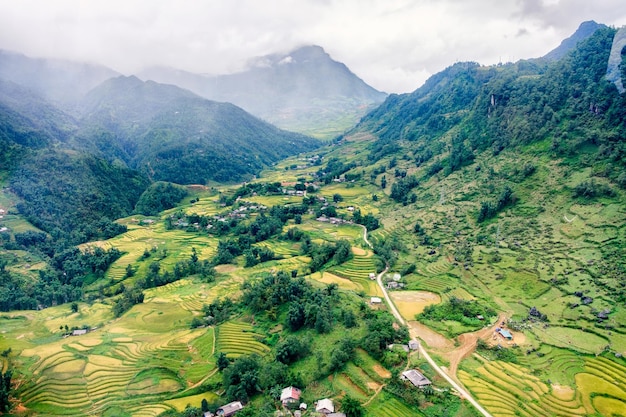 Aerial view of tribe village on rice field terraced in valley