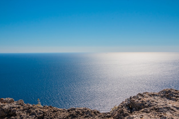 Aerial view on Turquoise Lagoon. Tropical Beach. Scenic Seascape. Rocky coast line. Summer vacation concept. Copy space. Deep blue water