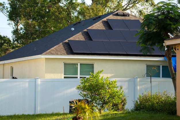 Aerial view of typical american building roof with rows of blue solar photovoltaic panels for producing clean ecological electric energy Renewable electricity with zero emission concept