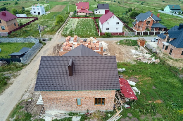 Aerial view of unfinished frame of private house under construction in suburban area.