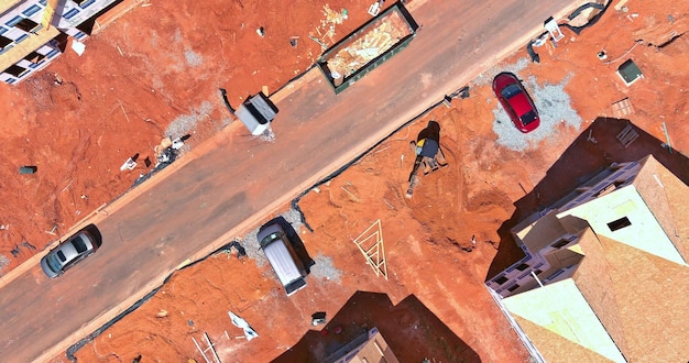 Aerial view of unfinished house with wooden roof frame structure under construction