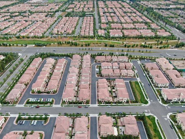 Aerial view of urban sprawl Suburban packed homes neighborhood with road Subdivision