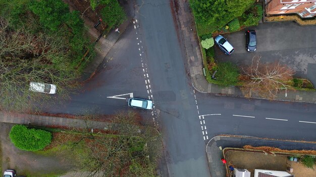 Aerial view of vehicles travelling on roads in the suburbs in a town in the UK