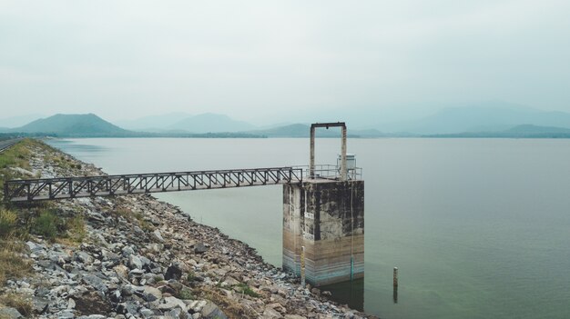 Aerial view of water level gate used in small lake dam for control water flow.