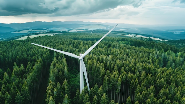 Aerial view of a wind turbine in a lush green forest