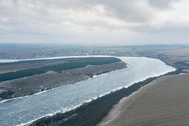 Aerial view of a winding frozen river in winter heavy frost beautiful winter landscape