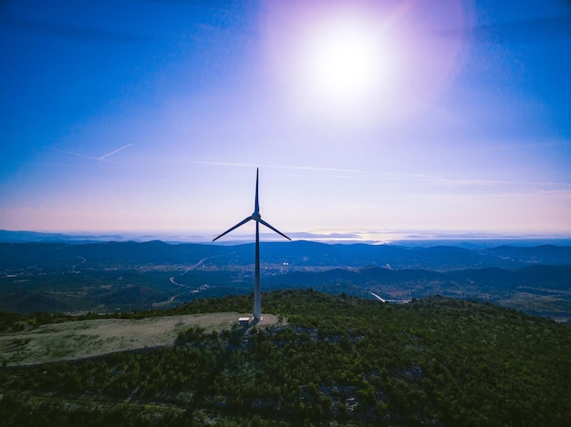 Aerial view of Windmill Energy Farm at sunset Wind turbines for electric power with clean and Renewable Energy