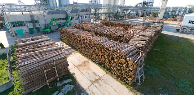 Aerial view of wood processing factory with stacks of lumber at plant manufacturing yard