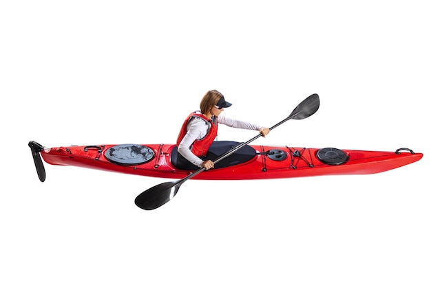 Aerial view of young woman in red canoe kayak with a life vest and a paddle isolated on white