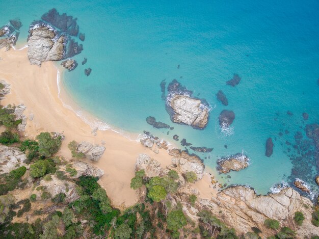 Aerial views of the rocks in the sea on a sunny day.