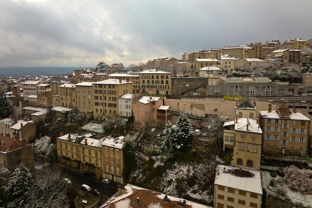 Aerial winter landscape of dense historic center of Thiers town in PuydeDome department AuvergneRhoneAlpes region in France Rooftops of old buildings and narrow streets at snowfall