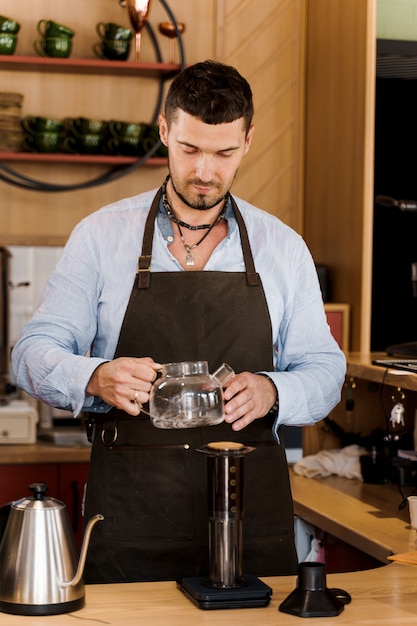 Aeropress coffee and handsome bearded barista in cafe