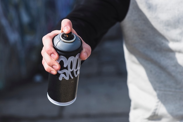 Aerosol spray can in human hand