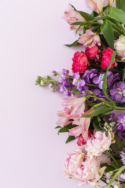 Aesthetic background with colourful rose flowers on pink background Beautiful floral composition