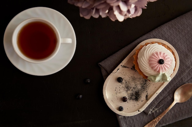 Aesthetic breakfast tea time Cake with currant and cup of black tea Copy space Autumn good mood