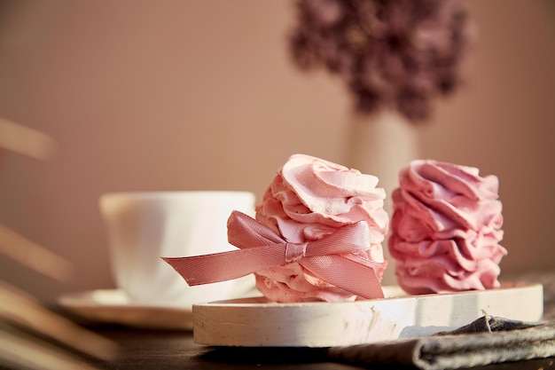 Aesthetic dessert berry marshmallows with currant and cup of black tea Blurred foreground Autumn cozy atmospheric appetizer Healthy sweets natural food sugar and gluten free