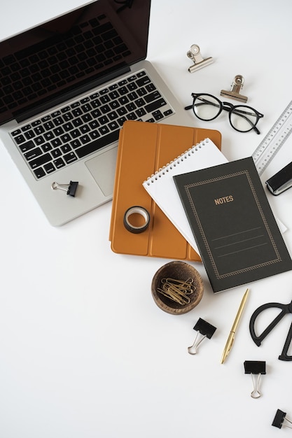 Aesthetic home office desk workspace with laptop computer notebook tabled pad on white background Flat lay top view blog website social media concept