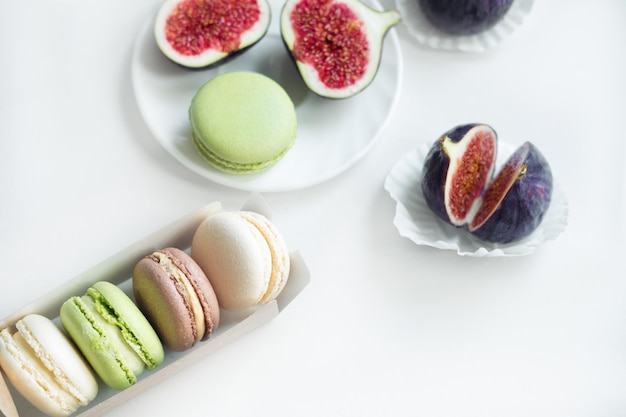 Aesthetic layout of figs and macarons on a white background top view