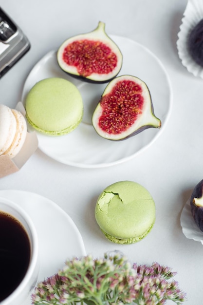 Aesthetic layout of figs and macarons on a white background top view