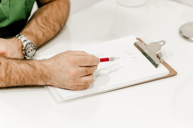 Photo aesthetic surgeons hand pointing at a document illustrating professional consultation