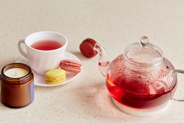 Aesthetic tea time at cozy home Cup of tea with macaroons Herbal raspberry natural tea Cozy home self care wellness lifestyle