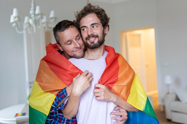 Affectionate Male gay couple indoors Man embracing his boyfriend from behind at home Gay couple celebrating pride month