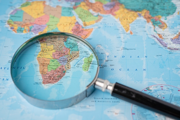 Africa, Magnifying glass close up with colorful world map 