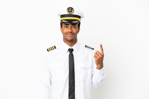 African American Airplane pilot over isolated white background pointing with the index finger a great idea