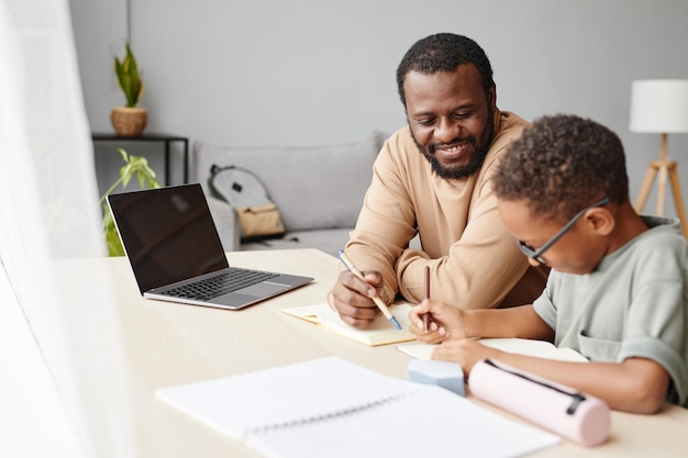 African American Boy Studying with Father at Home