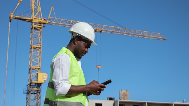 African american builder types report on smartphone by crane