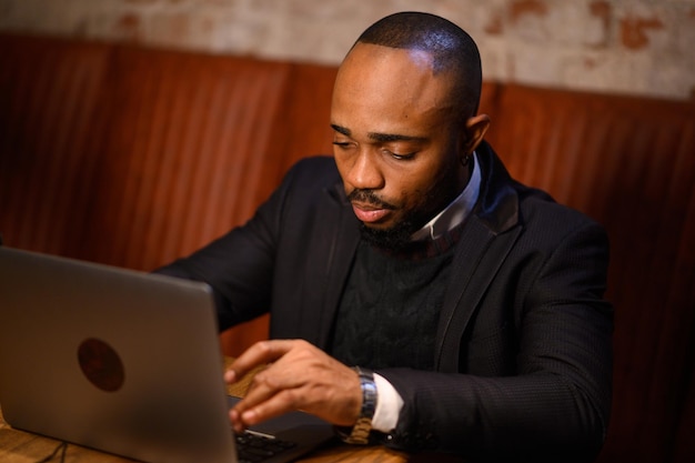 African american business man student entrepreneur study online course with laptop serious young mix...