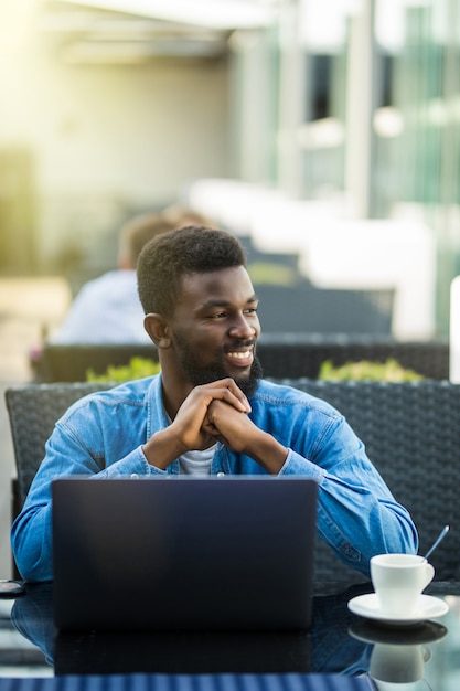 African american business man with laptop in a cafe