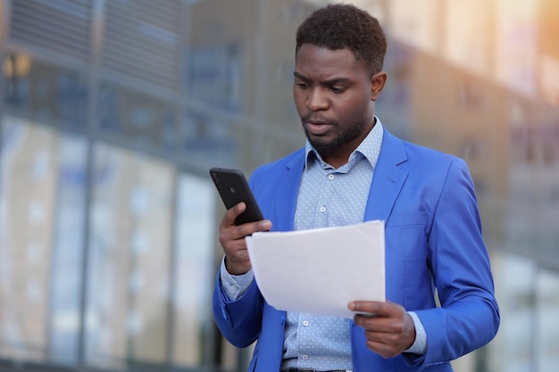 African american businessman examines monthly paper report