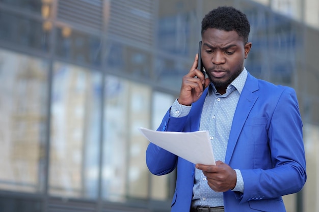 African american businessman examines monthly paper report