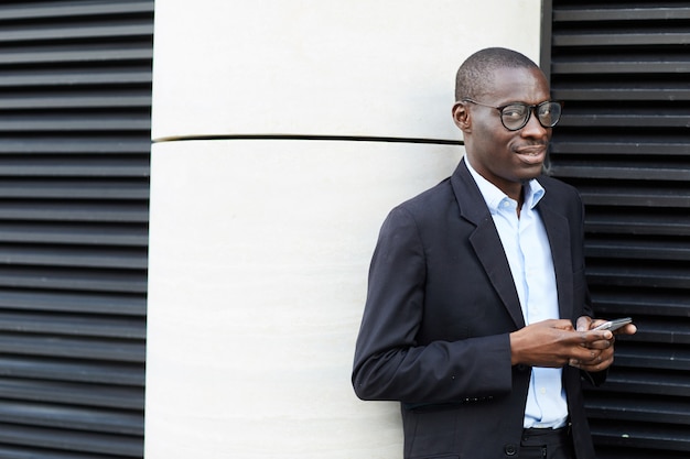 African-American Businessman using Smartphone Outdoors