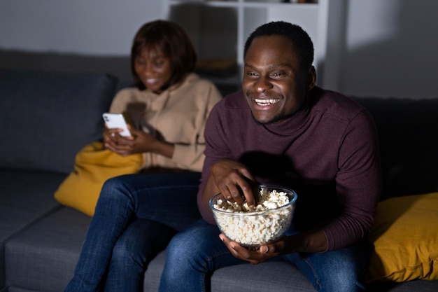 African american couple watching streaming service together at home