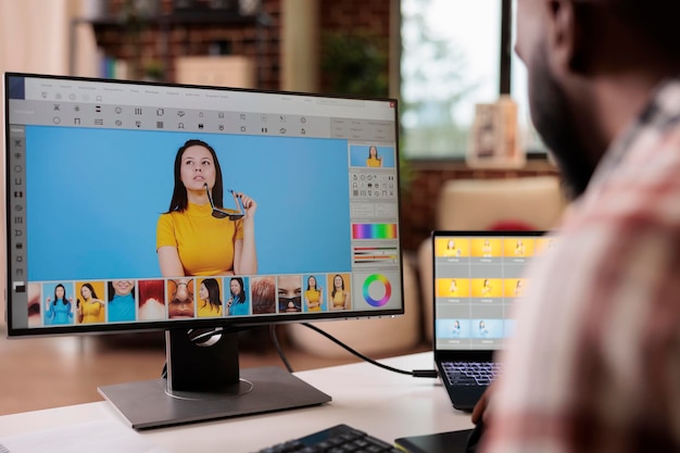 African american editor using retouching software to edit photo, creating professional photography content. Freelancer artist editing image with color grading and retoucher interface.