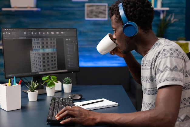 African american engineer drinking coffee analyzing building construction plan