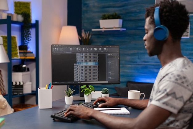 African american engineer man with headphones analyzing architecture sketch