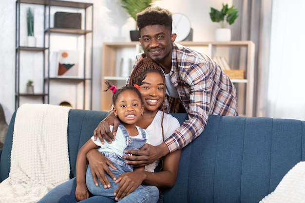 African american family posing on comfy couch at home