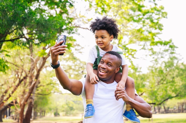 African American father and son selfie together