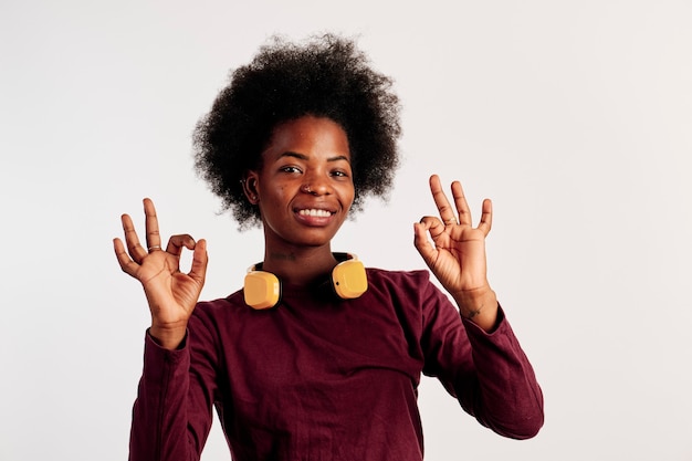 African American girl in brown sweater poses showing her hands