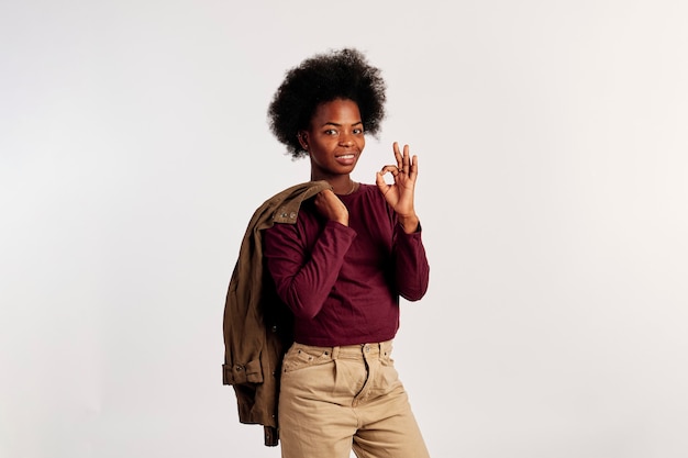 African American girl in brown sweater poses showing her hands