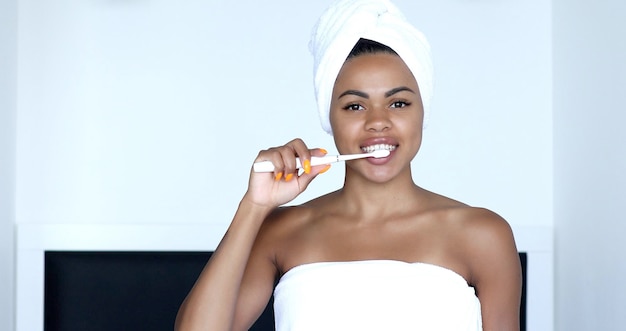 African American Girl Brushing Teeth With Toothbrush.