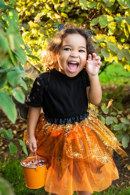 African American girl dressed as a witch and cat ears wizard for halloween Trick or treat